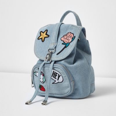 Girls blue denim badge backpack